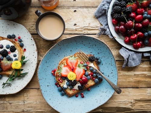 Brunch food on plates on a wooden table