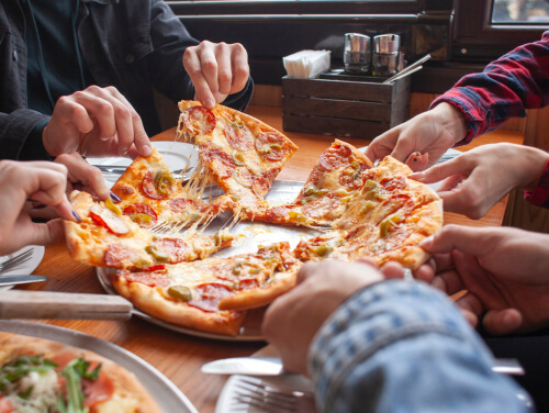A group of people sharing a pizza