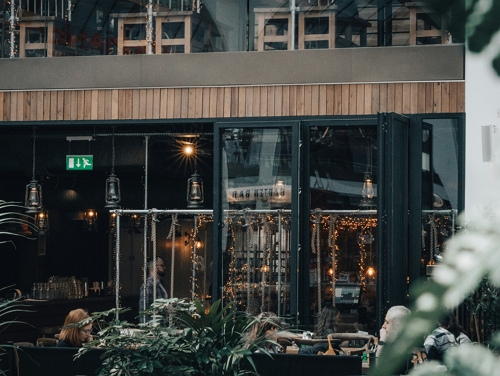 A bar in Manchester's Northern Quarter with fairy lights dangling from the windows