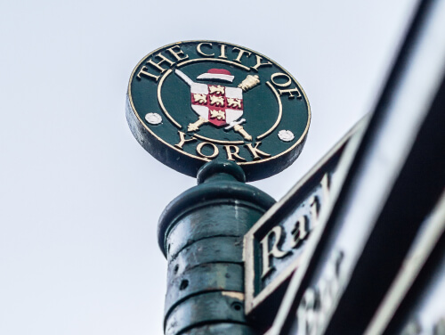 The City of York sign on a railing in the city