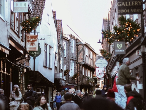 The Shambles in York in the daytime with lots of people walking down it